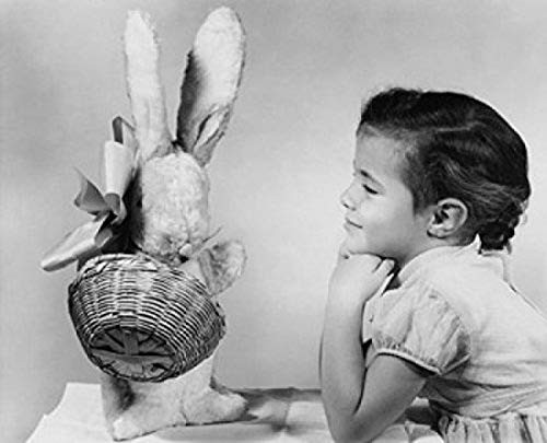 Side profile of a girl looking at a stuffed rabbit and smiling Poster Print (18 x 24)
