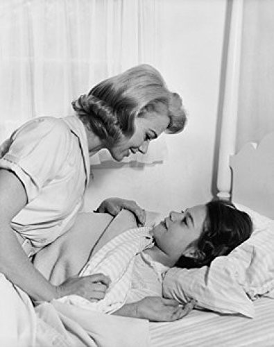 Side profile of a mother tucking in her daughter Poster Print (18 x 24)