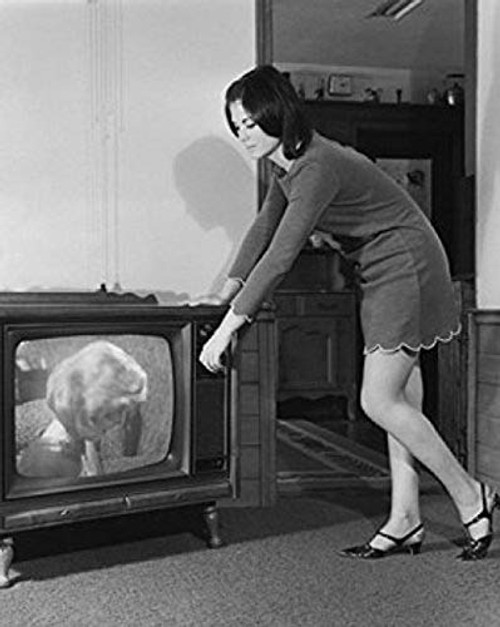 Posterazzi Side Profile of a Young Woman Changing Channels of a Television Poster Print (18 x 24) Varies Posterazzi Side Profile of a Young Woman Changing Channels of a Television Poster Print (18 x 24) Varies
