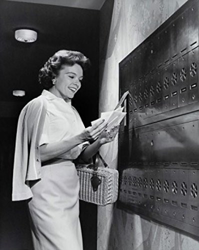 Posterazzi Side profile of a young woman collecting mail from a mailbox Poster Print (18 x 24)