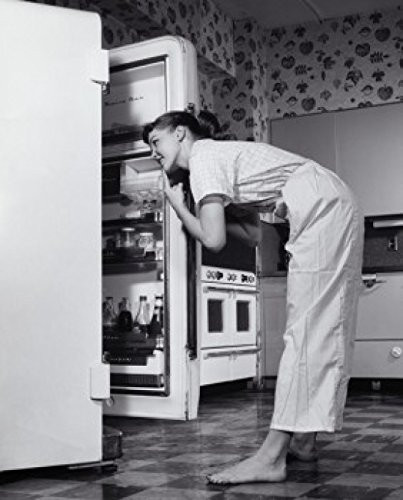 Posterazzi Side profile of a young woman looking in a refrigerator Poster Print (18 x 24)
