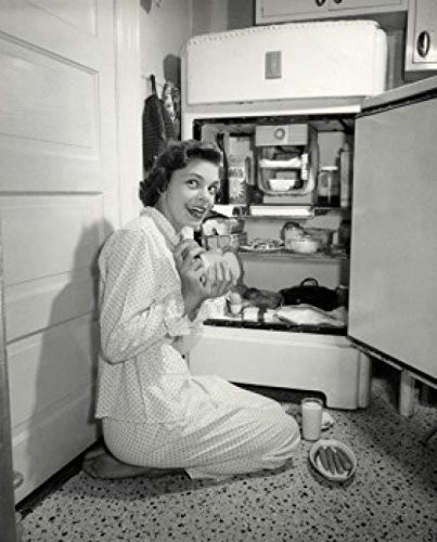 Posterazzi Side profile of a young woman taking out food from a refrigerator Poster Print (18 x 24)