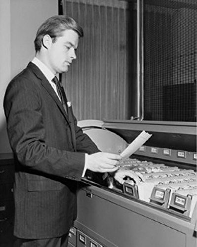 Posterazzi Side profile of businessman reading document beside filing cabinet Poster Print (18 x 24)