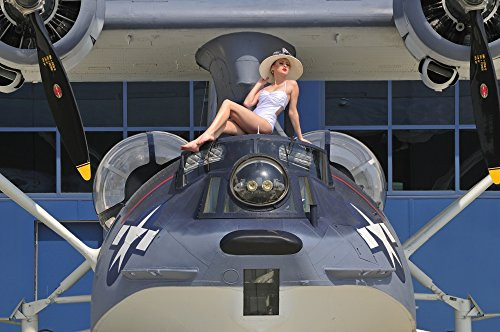 Posterazzi PSTCHK100042M Retro pin-up girl posing with a World War II era PBY Catalina seaplane Poster Print, 17 x 11