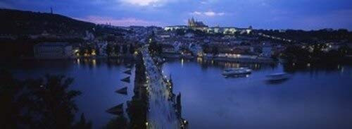 Posterazzi High angle view of buildings lit up at dusk Charles Bridge Vltava River Prague Czech Republic Poster Print, (18 x 7)