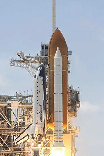 Space shuttle Atlantis twin solid rocket boosters and three main engines ignite to propel the spacecraft off Kennedy Space Centers Launch Pad 39A Post
