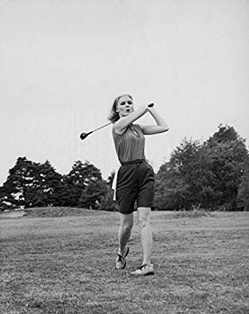 Posterazzi Young woman swinging club on golf course Poster Print  18 x 24