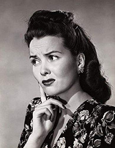 Closeup of a young woman with her finger on her face Poster Print 18 x 24