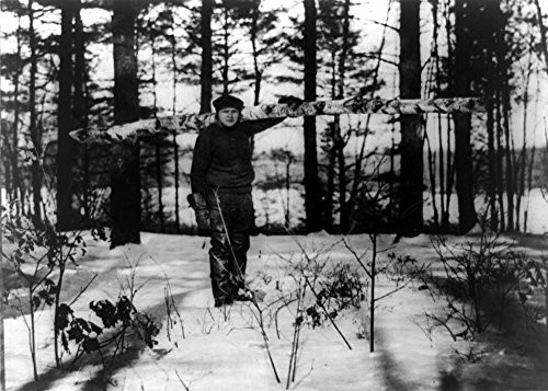 George H Ruth 18951948 Nknown As Babe Ruth American Professional Baseball Player Ruth Carrying A Large Log For A Stove 1920S Poster Print by 18 x 24
