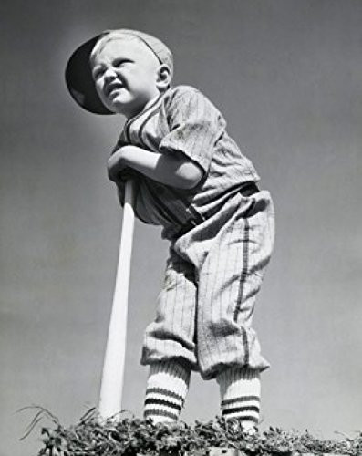 Low angle view of a boy leaning on a baseball bat Poster Print 18 x 24
