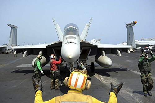 Posterazzi An aircraft director signals to the pilot of an F A 18F Super Hornet Poster Print   17 x 11