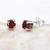 Sterling silver stud earrings with faceted garnet in prongs setting with sterling silver post and backing