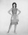 Portrait of young woman standing with arms akimbo Poster Print -18 x 24-