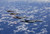 Posterazzi Four F-15 Eagles from the 67th Fighter Squadron in Kadena Air Base Okinawa Japan fly in formation over the Pacific Ocean during a training mission Poster Print, (17 x 11)