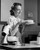 Posterazzi Side Profile of Young Woman Holding Cake and Smiling Poster Print, (18 x 24) Posterazzi Side Profile of Young Woman Holding Cake and Smiling Poster Print, (18 x 24)