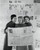Three young women reading a newspaper Poster Print (18 x 24)
