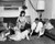Posterazzi Mid adult couple with their three children near a fireplace Poster Print, (18 x 24)