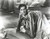 Laurence Olivier kneeling on a sofa Photo Print 10 x 8