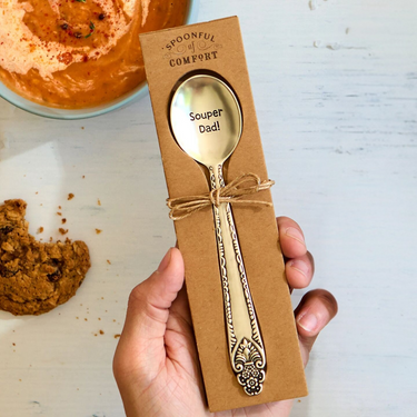 hand holding silver spoon that says Soup-er Dad