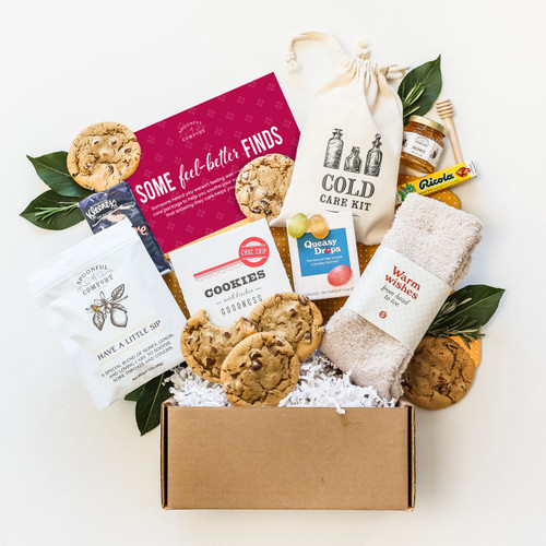 Mini Sick Day package with cold care kit, tea trio, honey and dipper, Cozy Socks, and package insert with text "Some Feel Better Finds"