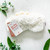 White faux-fur eye mask with product tag that reads "Do not disturb"