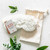 White fuzzy lavender-filled eye mask and canvas drawstring bag