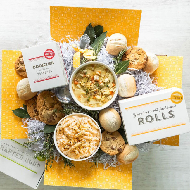 Combos of Care displayed with a bowl of Chicken Noodle and Mac n' Cheese, rolls and cookies