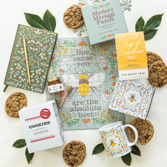 The Bee's Knees Package with Helmsie designed bee mug and journal, gold pen, Cup of Sunshine tea, mystery message puzzle and cookies