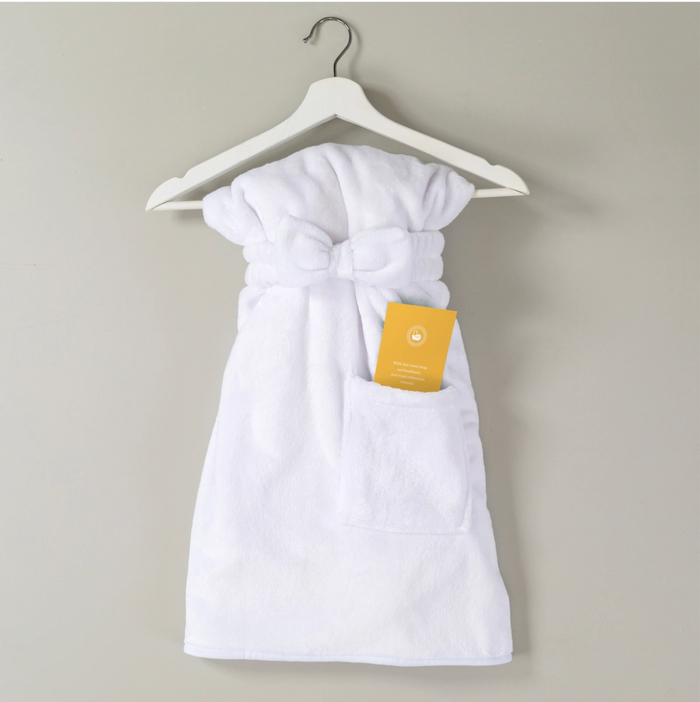 White robe tied at the waist, hanging on a hanger with a yellow tag attached.