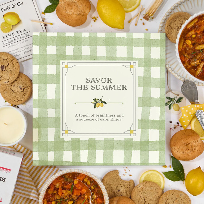 “Savor the Summer” Insert card centered on a striped cream and green background surrounded by bread, soup, cookies and lemons slices.
