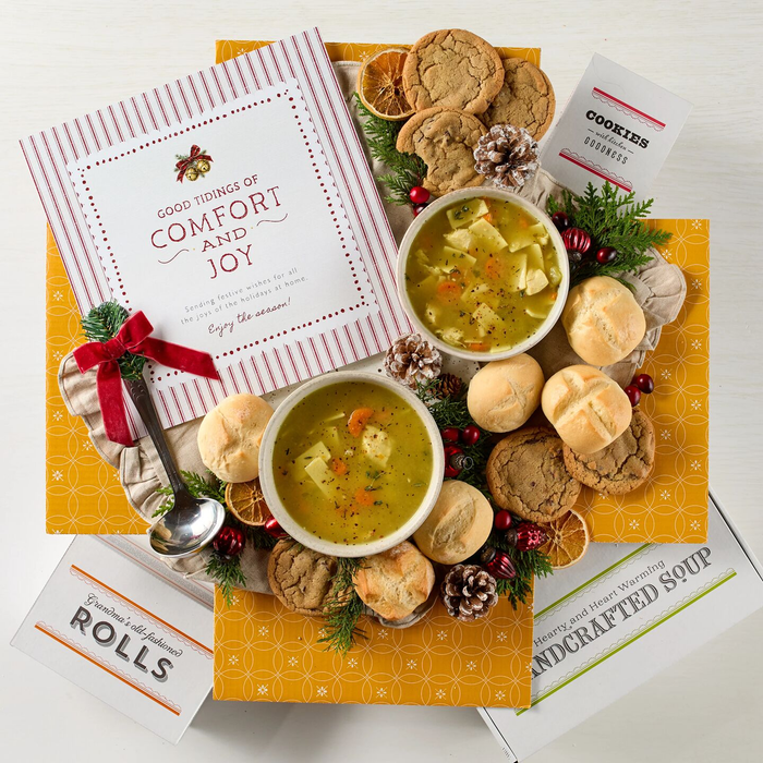 Soup package with a decorative insert, with two bowls of soup, rolls and cookies.