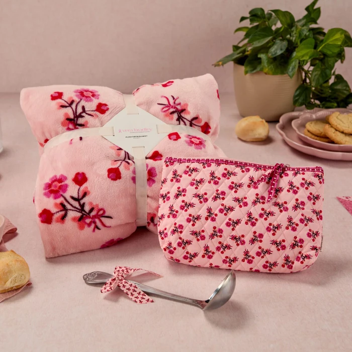 Overhead view of a Spoonful of Comfort gift featuring soup, rolls, cookies, a pink floral blanket, matching pouch, ladle, and “A Pattern of Comfort” gift packaging.  