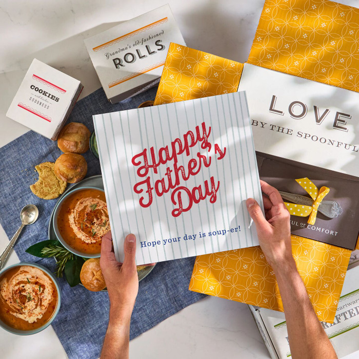 Overhead image of a Father’s Day promotional card beside packaged soup, bread rolls, and baked treats.