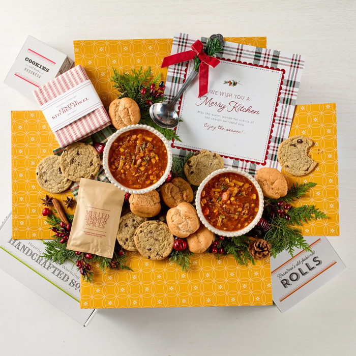 Soup package with a decorative insert, with two bowls of soup, rolls and cookies.