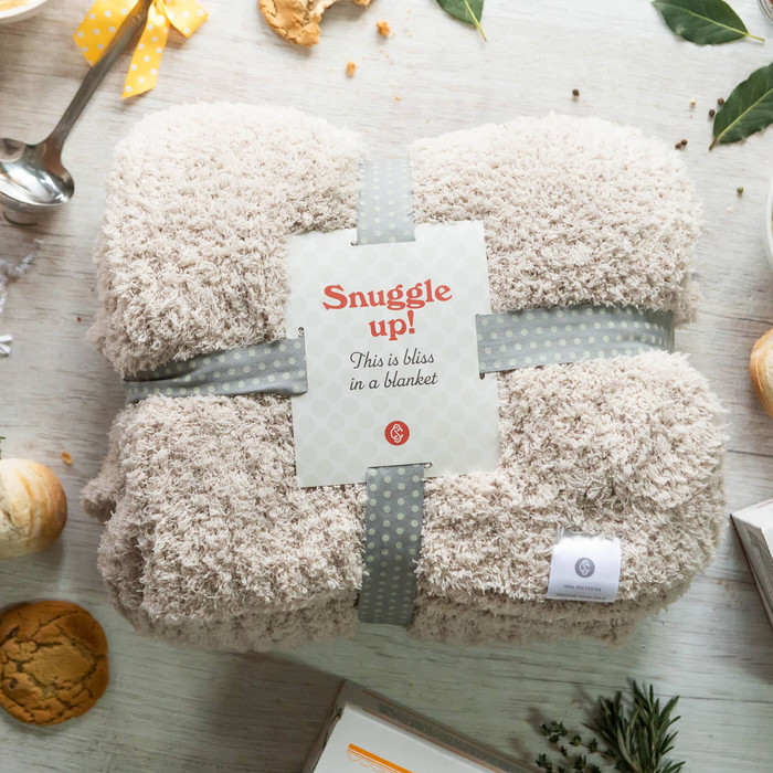 Cozy Comfort Throw with a product label with text Snuggle Up This is bliss in a blanket