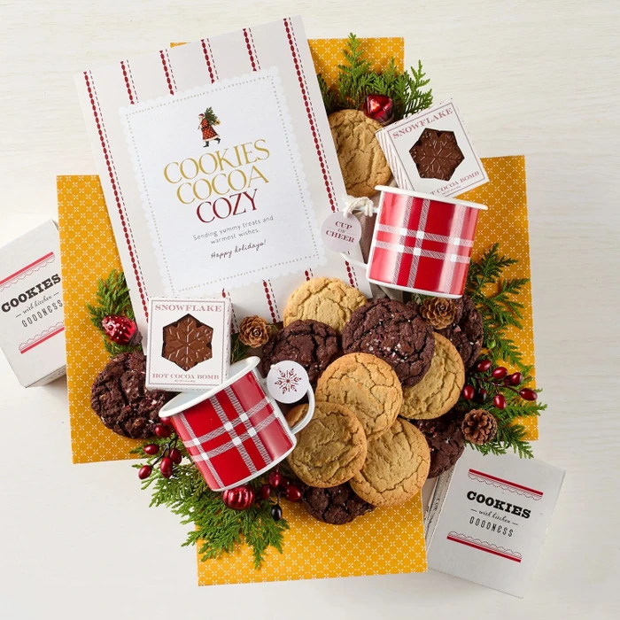 Festive Holiday Cookie Package with a decorative insert, and surrounded by cookie boxes and mugs.
