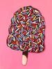 Sprinkles is a playful oil painting of a chocolate-dipped ice cream bar covered in colorful sprinkles, set against a vibrant pink background.