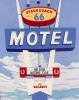 Joan Gladstone’s painting depicts the vintage Stagecoach 66 Motel sign in Seligman, Arizona, with bold blue, red, and cream lettering rising against a bright sky filled with soft white clouds. The Route 66 roadside sign features a “Welcome Mustang Club” marquee, horseshoe symbols, and a prominent “No Vacancy” panel.