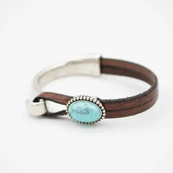 Turquoise gemstone with embossed leather and silver plating made in Montana USA.