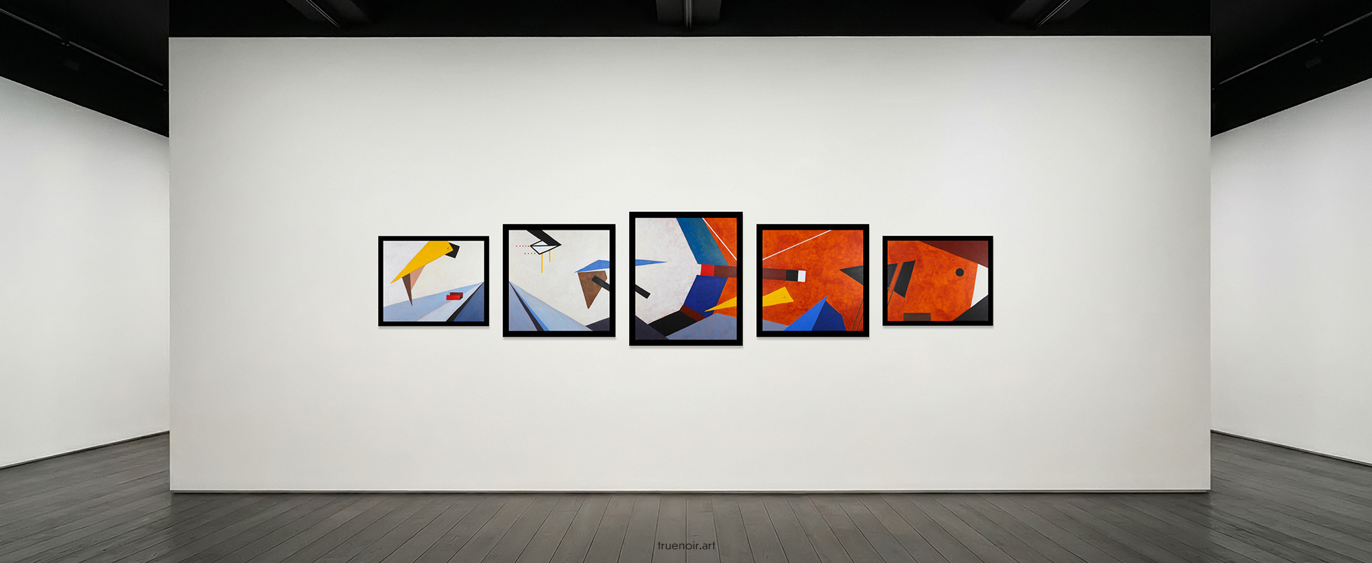 Five Infinite Cycle paintings in a gallery show room. The walls are white; the floor is dark wooden plank. Paintings are in black frames, spaced out evenly in the center of the photo. Depicted in these paintings is a play of geometric shapes and colors in blues, whites, and deep orange.