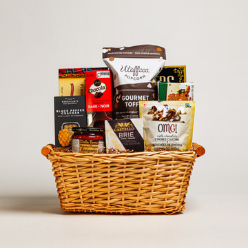 The Gourmet Delight Large is one of our best-selling gift baskets, filled with our favorite selection of traditional gourmet foods. It includes creamy Brie cheese, savoury antipasto, crisp crackers, delectable cookies, and a delightful mix of sweets. This generous assortment is perfect for sharing with friends, family, or clients on any occasion. Its elegant presentation makes it a thoughtful and impressive gift choice.