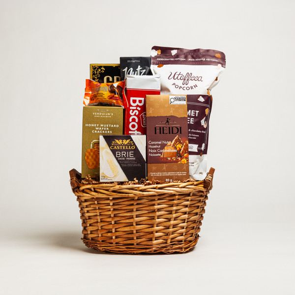 The Gourmet Delight Medium is a thoughtfully curated gift basket filled with a selection of traditional gourmet foods. Inside, recipients will find creamy Brie cheese, savoury antipasto, crisp crackers, delectable cookies, and fine European chocolate. This elegant arrangement is perfect for sharing with friends, family, or clients on any occasion. Its classic combination of flavors makes it a delightful treat for all to enjoy.