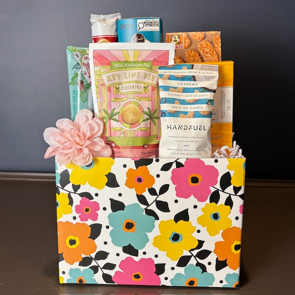 This brightly coloured floral blossoms gift box has the perfect mix of sweet and salty items that everyone will love! Cheesy crackers, buttery shortbread, and delicious imported European chocolate! Who can resist?! Order yours today! 