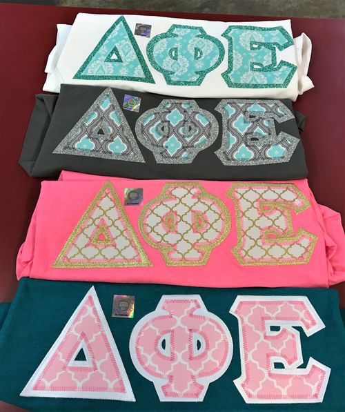 Delta Phi Epsilon Greek Letters, pink, grey, and white