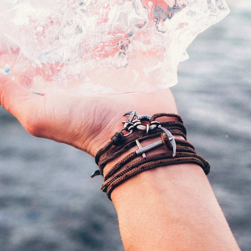 Rope And Silver Anchor Bracelets Holding Ice Rope And Silver Anchor Bracelets Holding Ice