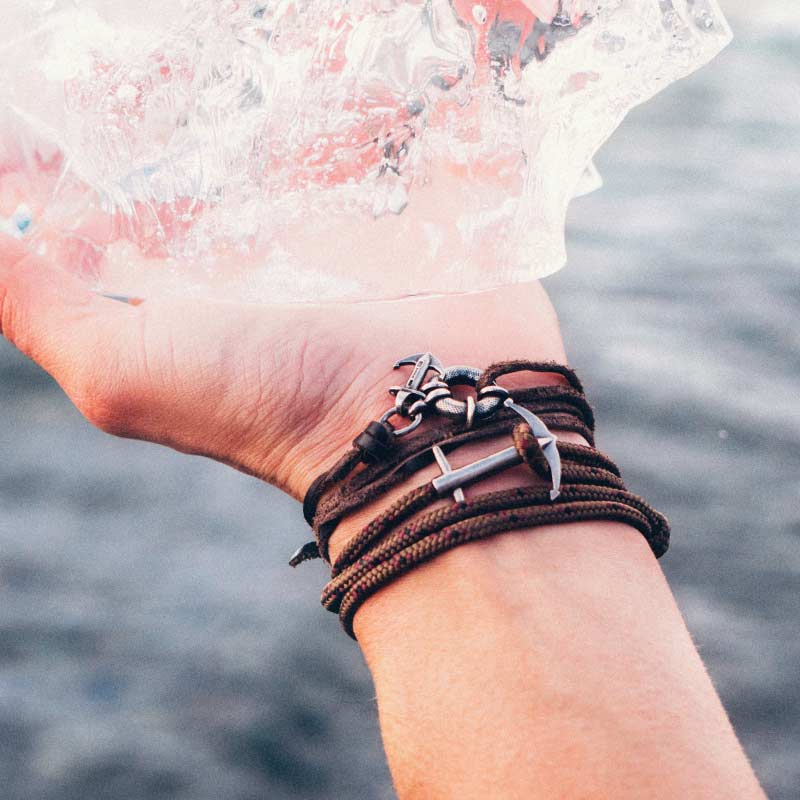 Rope And Silver Anchor Bracelets Holding Ice