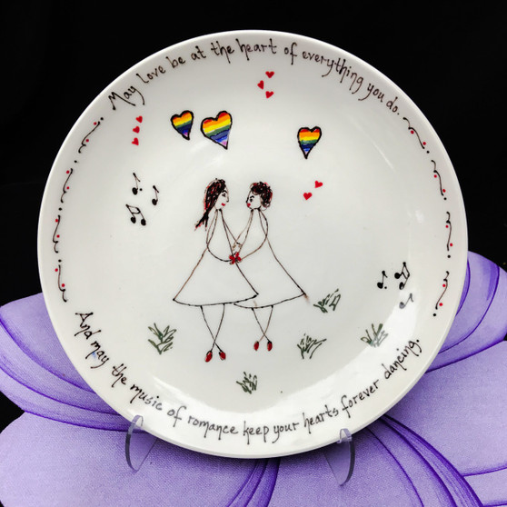 Pottery Mountain - This bowl has a line drawing of a female couple with rainbow hearts and music notes. "May love be at the heart of everything you do.  And may the music of romance keep your hearts forever dancing."