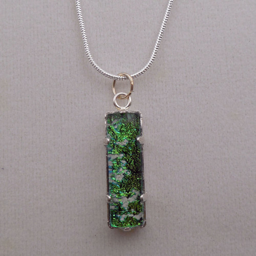 elegantly designed cremation pendant is exquisitely crafted of dichroic glass and silverplate setting