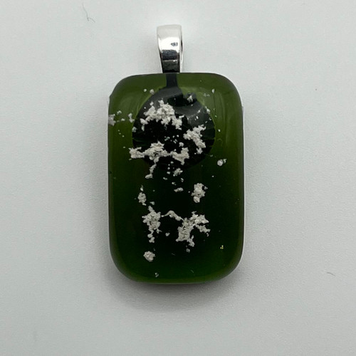 Green pendant with cremated ashes fused in glass to remember your loved ones
