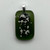 Green pendant with cremated ashes fused in glass to remember your loved ones